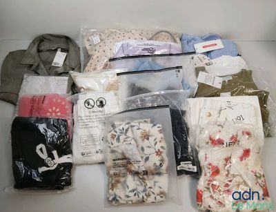 many bags of clothing that are sitting on a table