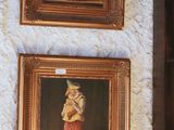 two paintings hanging on the wall of a room