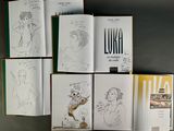 a lot of books that are sitting on a table