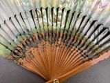 a close up of a fan with many designs on it