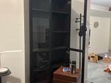 a room that has a bookcase and a desk in it