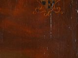 painting of a cross on a wooden door with a red sky in the background