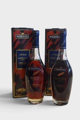two bottles of brandy and a box of wine on a white surface