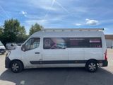 a white van parked in a parking lot with other vehicles