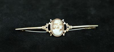 a close up of a gold ring with a pearl in it