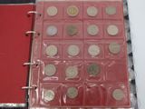 a red binder with a lot of coins in it