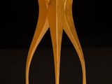 an image of a gold stool on a black background