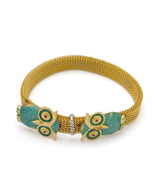 an image of a gold and turquoise bracelet with two fish on it