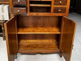 an image of a wooden desk with drawers and a shelf