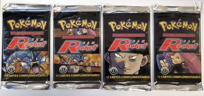 four packs of pokemon trading cards on a white surface