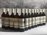 several bottles of wine are lined up on a counter