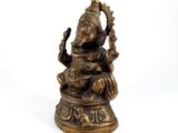 brass statue of the hindu god ganesha on a white background