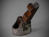 an old planer with a wooden handle sitting on a table