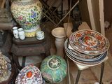 many plates and bowls sitting on a table in a room