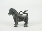 a small statue of a horse with a long tail