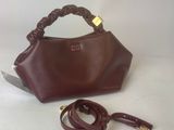 brown leather handbag with handle and strap on white background