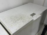 two white refrigerators in the corner of a room