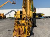 a yellow crane that is sitting in a parking lot