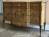 a dresser with a marble top on a herringle floor
