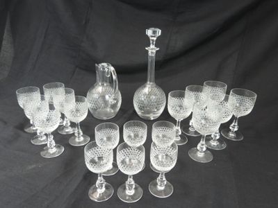 a lot of wine glasses and a decanter on a table