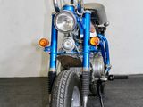 a blue motorcycle that is parked in a garage