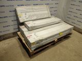 three mattresses stacked on a pallet in a room