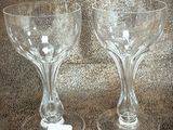 two wine glasses sitting on a table with a price tag