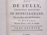 an old book that is open on a table