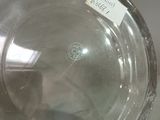 a glass vase with a label on it sitting on a table