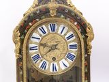a clock that has a statue on top of it