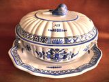 a blue and white dish with a bird on it
