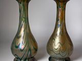 two vases sitting side by side on a white surface