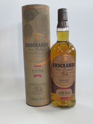 an image of a bottle of knockand whisky next to a cardboard box