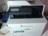 a printer sitting on top of a table in a room