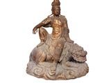 statue of a man sitting on a rock with a dog