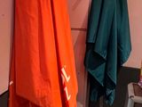 two umbrellas hanging on the wall in the bathroom