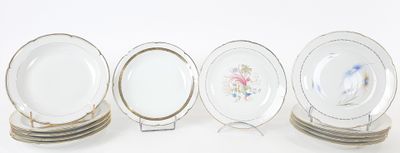 four plates are lined up in a row on a white surface