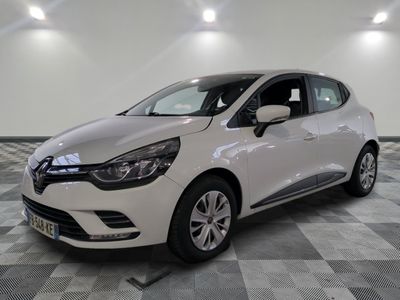 the white car is parked on a checkered tile floor