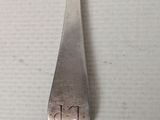 a close up of a spoon on a table with writing on it