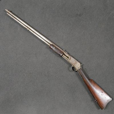 a rifle with a wooden barrel and a metal handle