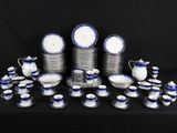 a lot of blue and white dishes and cups on a table