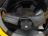 a close up of a helmet with a leather strap on it