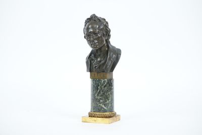 un buste en bronze représentant un homme, posé sur un socle en marbre