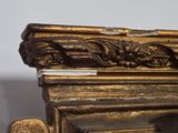 a close up of a gold frame with a clock on it