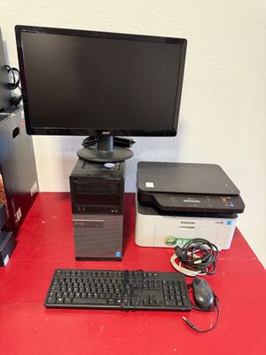 a desktop computer sitting on a red desk next to a printer