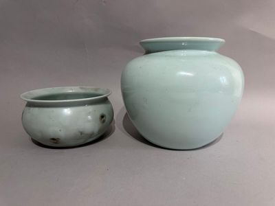 two vases sitting next to each other on a table