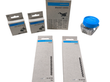 two boxes of blue ink and a blue cap on a white background