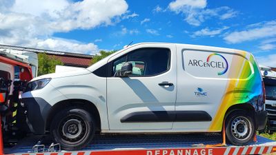 a white van on the back of a flatbed tow truck