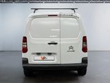 the back of a white van is parked in a garage