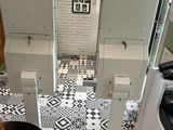 a black and white tiled floor in a small kitchen